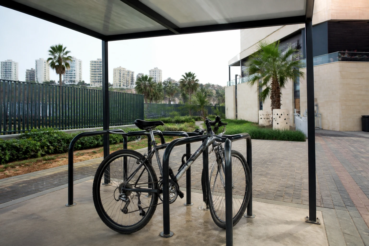 Bicycle parked at a covered urban rack.