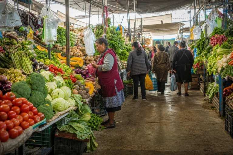 Colorful produce displays inside a Lima food market