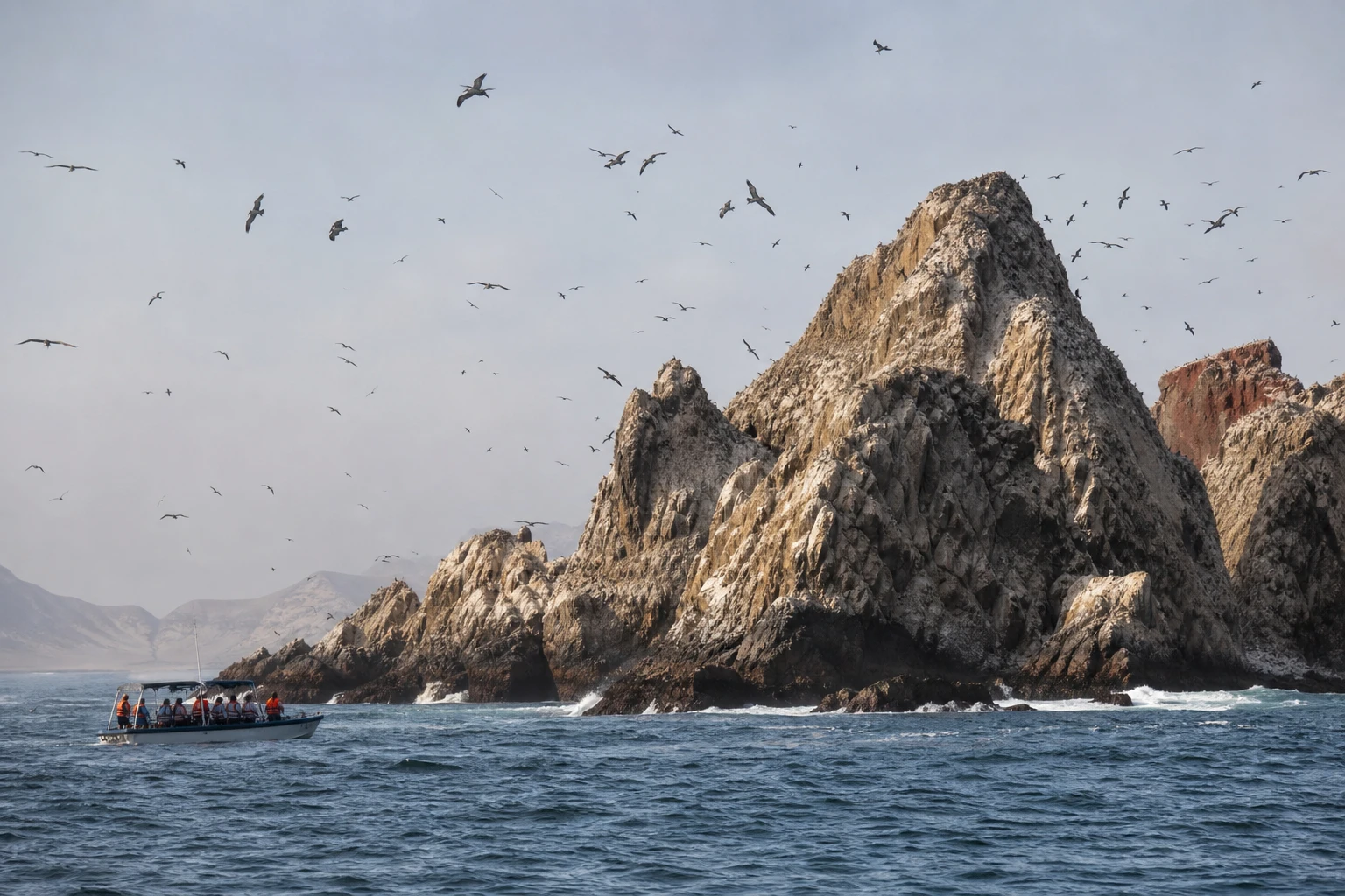Tour boat near the rocky Palomino islets off Callao