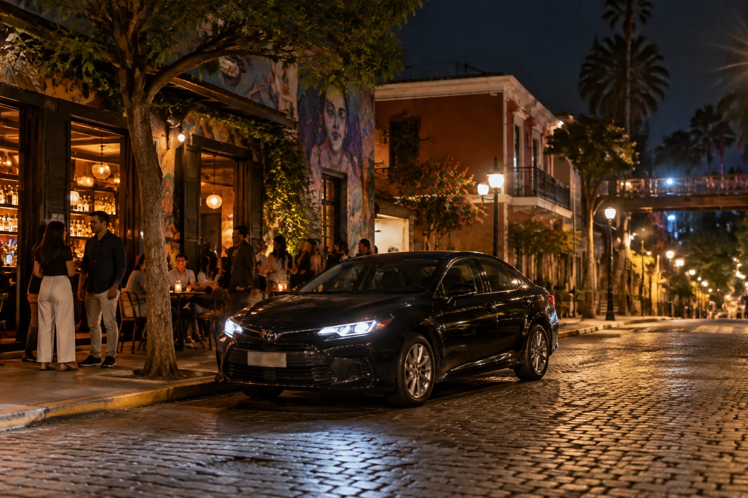 Car waiting at a lit curb for a nighttime return from Barranco